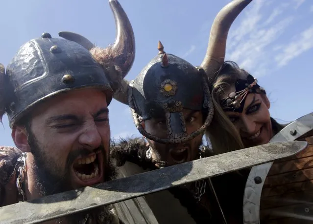 People dressed up as Vikings take part in the annual Viking festival of Catoira in north-western Spain August 2, 2015. (Photo by Miguel Vidal/Reuters)