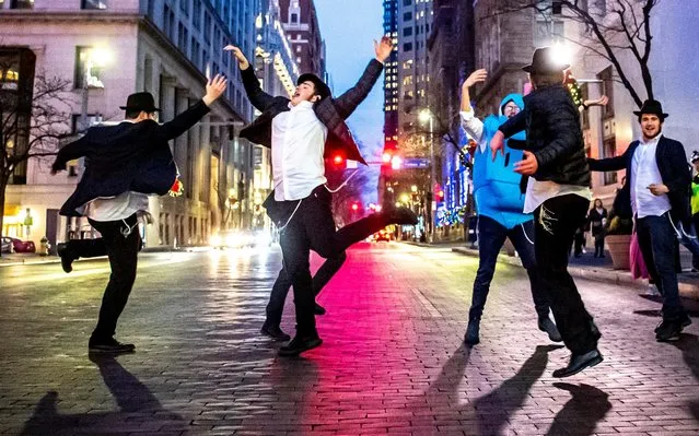 Yeshiva School students briefly dance on Grant Street after the menorah lighting outside of the City-County Building for the fifth night of Hanukkah, Thursday, December 26, 2019, in downtown Pittsburgh. (Photo by Alexandra Wimley/Pittsburgh Post-Gazette via AP Photo)