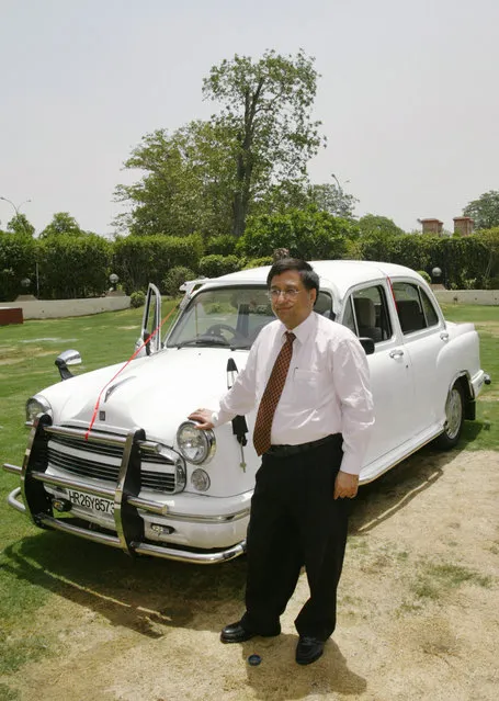 Ashwani Dubey, Executive Vice President of Hindustan Motors, launches a new Ambassador CNG Bharat Stage (BS) III car in New Delhi, India, Wednesday June 15, 2005. The car which comes with a 74 BHP engine and a factory fitted compact natural gas kiT, will come in several models ranging from about $8,800 to about $11,100. (Photo by Saurabh Das/AP Photo)