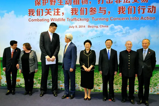 In this U.S. Department of State handout, U.S. Secretary of State John Kerry (4L) talks with former NBA player Yao Ming (3L) after thanking him for his activism during an anti-wildlife trafficking event on the sidelines of the sixth U.S.-China Strategic and Economic Dialogue on July 9, 2014 in Beijing, China. (Photo by U.S. Department of State via Getty Images)