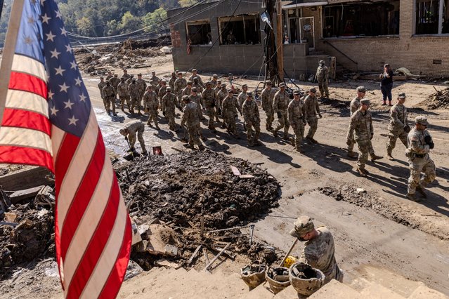 Army soldiers from 1st Battalion, 502nd Infantry Regiment, 101st Airborne Division arrive to help residents to remove debris and clean the area following the passing of Hurricane Helene, in Marshall, North Carolina, U.S., October 8, 2024. (Photo by Eduardo Munoz/Reuters)