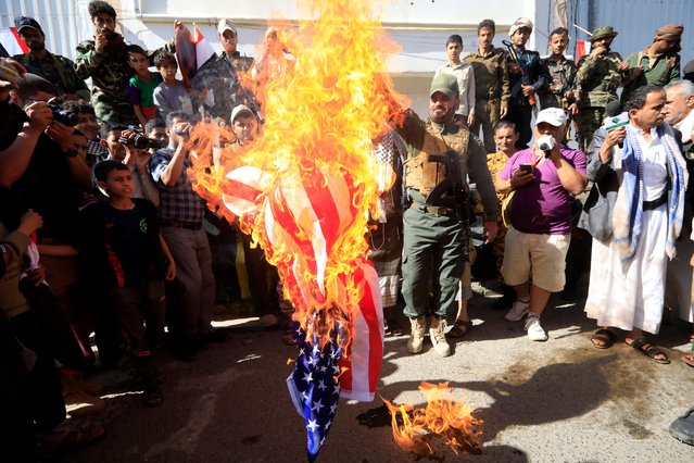 Houthi soldiers burn a US flag during a parade on the 34th anniversary of Yemen's unification, in Sana'a, Yemen, 22 May 2024. Yemen marks the 34th anniversary of the unification of North and South Yemen on 22 May 1990, as the Houthis continue to consolidate their grip over large parts of northern Yemen, including the capital Sana'a, since 2015 while Yemen's internationally recognized government controls southern Yemen. (Photo by Yahya Arhab/EPA/EFE)