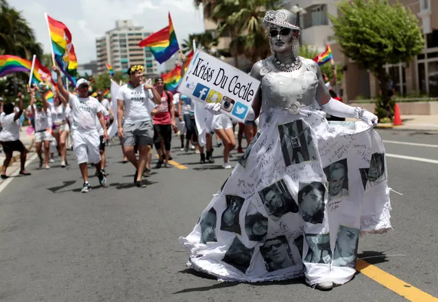 A participant wears a dress printed with the faces of the Puerto Rican victims of the shooting at the Pulse night club in Orlando, during the annual gay pride parade in San Juan, Puerto Rico, June 26, 2016. (Photo by Alvin Baez/Reuters)