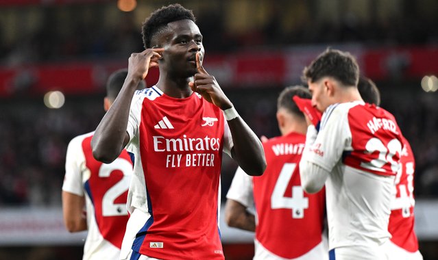 Bukayo Saka of Arsenal celebrates scoring his team's first goal during the Premier League match between Arsenal FC and Liverpool FC at Emirates Stadium on October 27, 2024 in London, England. (Photo by Stuart MacFarlane/Arsenal FC via Getty Images)