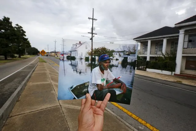 Photographer Carlos Barria holds a print of a photograph he took in 2005, as he matches it up at the same location 10 years on, in New Orleans, United States, August 16, 2015. The print shows Errol Morning sitting on his boat on a flooded street September 5, 2005, after Hurricane Katrina struck. (Photo by Carlos Barria/Reuters)