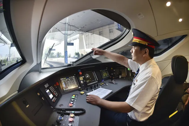 In this August 21, 2017 photo released by China's Xinhua News Agency, a train driver prepares to operate the Fuxing bullet train, China's latest high-speed train, to Beijing from northern China's Tianjin Municipality. (Photo by Yang Baosen/Xinhua via AP Photo)