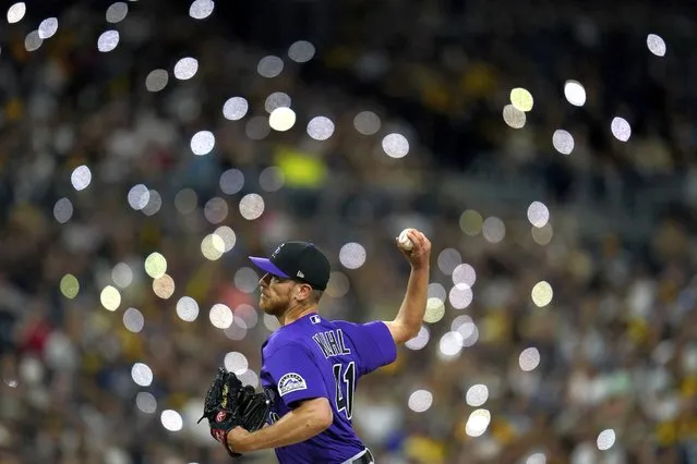 Colorado Rockies starting pitcher Chad Kuhl works against a San Diego Padres batter as fans turn on lights on their phones during the sixth inning of a baseball game Wednesday, August 3, 2022, in San Diego. (Photo by Gregory Bull/AP Photo)