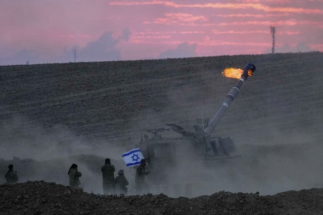 An Israeli mobile artillery unit fires a shell from southern Israel toward the Gaza Strip, in a position near the Israel-Gaza border, Israel, Saturday, October 14, 2023. (Photo by Maya Allerruzzo/AP Photo)