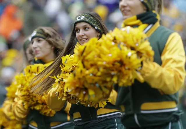 Cheerleaders perform during the first half of an NFL football game between the Green Bay Packers and the Minnesota Vikings Sunday, November 24, 2013, in Green Bay, Wis. (Photo by Jeffrey Phelps/AP Photo)