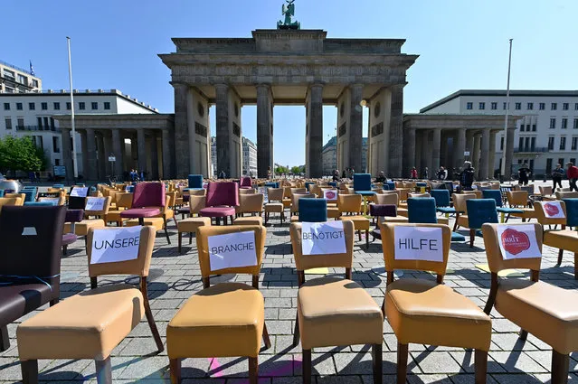 Empty chairs with notes reading “Our business needs help” stand in front of Berlin's landmark the Brandenburg Gate during a protest of gastronomers on April 24, 2020 amid the novel coronavirus COVID-19 pandemic. Restaurant owners across the country took part in the protest titled “Leere Stuehle” (empty chairs) organised by the gastronomers' network Leaders Club and staged in several German cities with similar actions. (Photo by John Macdougall/AFP Photo)