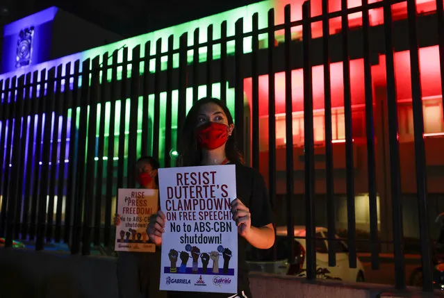 Activists hold slogans outside the headquarters of broadcast network ABS-CBN corp. on Tuesday, May 5, 2020 in Quezon city, Metro Manila, Philippines. A Philippine government agency has ordered the country's leading broadcast network, which the president has targeted for it's critical news coverage, to halt operations after its congressional franchise expired, sparking shock over the loss of a major news provider during the coronavirus pandemic. (Photo by Aaron Favila/AP Photo)