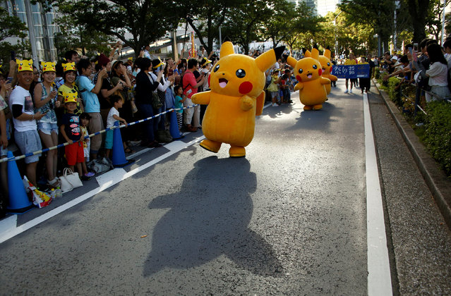 Performers wearing Pokemon's character Pikachu costumes take part in a parade in Yokohama, Japan, August 7, 2016. (Photo by Kim Kyung-Hoon/Reuters)