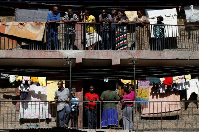 Residents watch as opposition supporters protest in the slum area of Mathare in Nairobi, Kenya on October 26, 2017. (Photo by Siegfried Modola/Reuters)