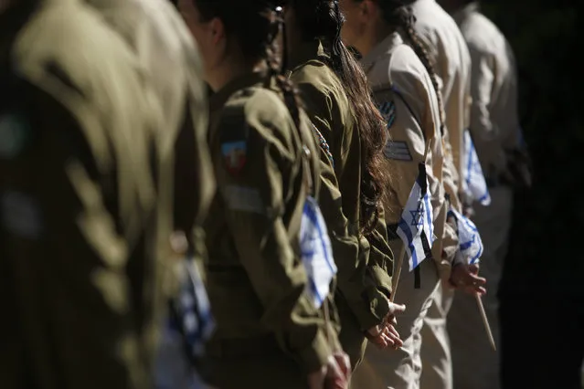 Israeli soldiers hold flags before placing them on the graves of fallen soldiers during a ceremony at the Mount Herzl military cemetery in Jerusalem, ahead of Memorial Day, April 10, 2013. (Photo by Ronen Zvulun/Reuters)