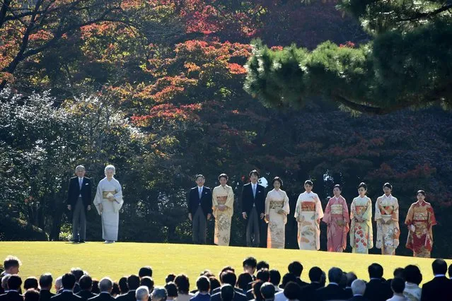 Japan's Emperor Akihito (L) and Empress Michiko (2nd L) pose with family members (from 3rd L to R) Crown Prince Naruhito, Crown Princess Masako, Prince Akishino, Princess Kiko, Princess Mako, Princess Akiko, Princess Yoko, Princess Tsuguko and Princess Ayako during an Imperial garden party at Akasaka Palace Imperial garden in Tokyo on November 9, 2017. (Photo by Toshifumi Kitamura/AFP Photo)