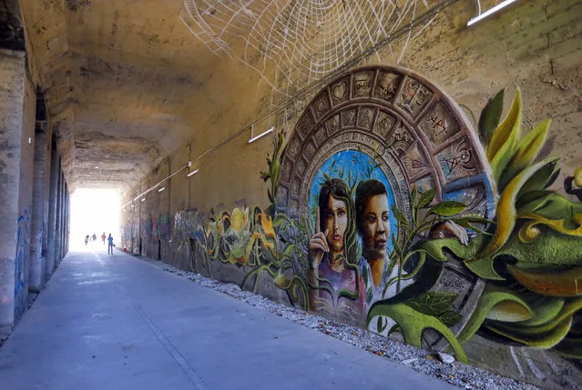 The mural “Coexistence” by Miguel Dominguez painted inside a railroad tunnel during a tour of the 2017 Art on the Atlanta BeltLine exhibition along the Westside Trail in Atlanta, Georgia, USA, 26 October 2017. The largest temporary public art exhibition in the southern United States continues through November 2017, with many installations remaining along the miles of the public byway. (Photo by Erik S. Lesser/EPA/EFE)