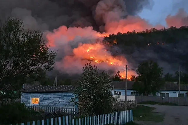 A wildfire in a forest near the village of Anavgai in Bystrinsky District, Kamchatka Territory, Russia on June 17, 2020. (Photo by Russian Emergencies Ministry/TASS)