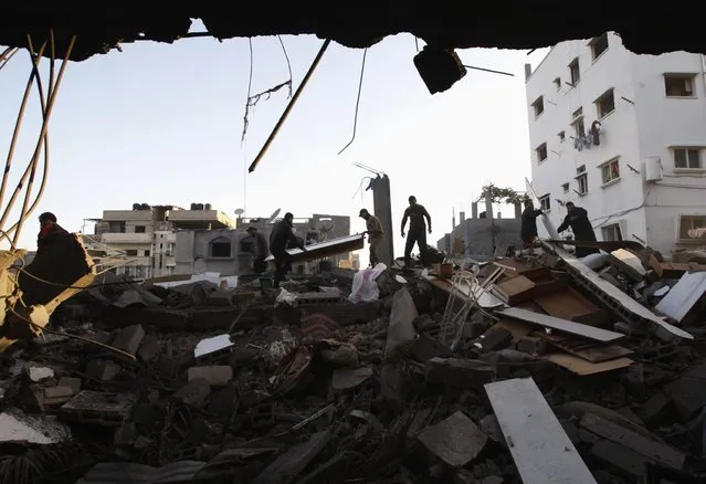 Palestinians inspect a destroyed house after an Israeli air strike in Gaza City November 18, 2012. Israel bombed militant targets in Gaza for a fifth straight day on Sunday, launching aerial and naval attacks as its military prepared for a possible ground invasion, though Egypt saw “some indications” of a truce ahead. (Photo by Ahmed Zakot/Reuters)