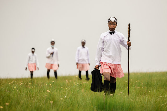 Followers of the Nazareth Baptist Church dressed in traditional attire, from the Ekuphakameni group, also known as the Shembe Church, get ready to take part in a dance at the Nhlangakazi Holy Mountain in Ndwedwe, 85 kilometres north of Durban, on January 7, 2024. The devotees climb the mountain as part of their annual 10 day pilgrimage. The church was founded in 1913 and is one of the largest African traditionalist church in Africa. They walk up to 68kms barefoot praying, worshipping, singing, dancing and camping on their four weeks stay at the mountain. The Shembe Church is the oldest independent indigenous Church in Southern Africa. (Photo by Rajesh Jantilal/AFP Photo)