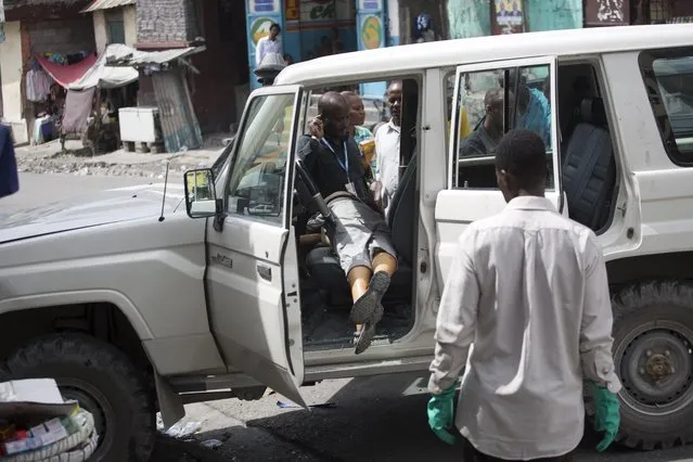 The body of slain Spanish nun Isabelle Sola Matas lies in her car in downtown Port-au-Prince, Haiti, Friday, September 2, 2016. Local judge Noel Jean Brunet said that two men on a motorcycle drove by and killed the 51-year-old Roman Catholic nun while she was driving. Matas worked at St. Joseph church where she directed a program providing people with prosthetic limbs. (Photo by Dieu Nalio Chery/AP Photo)