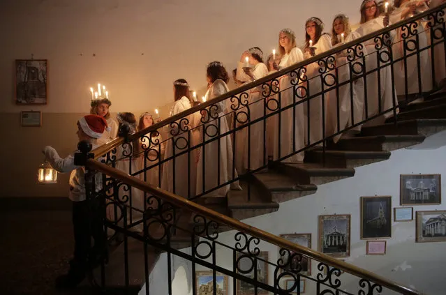 Youths wait to perform during the celebration of St. Lucia's Day at the Swedish Evangelical and Lutheran church of St. Katarina in St. Petersburg, Russia December 13, 2017. (Photo by Anton Vaganov/Reuters)