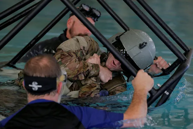 Soldiers from the 1st Armored Division, Combat Aviation Brigade, train on how to react if a helicopter crashes into the water before heading to Puerto Rico in order to aid in recovery efforts following Hurricane Maria at Fort Bliss in El Paso, Texas, U.S., September 29, 2017. (Photo by Lucas Jackson/Reuters)