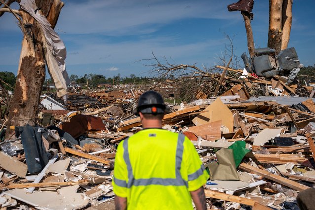 A volunteer looks on as cleanup continues in the Sunshine Hills neighborhood after a series of tornadoes hit Laurel County, in London, Kentucky, on May 17, 2025. (Photo by Seth Herald/Reuters)