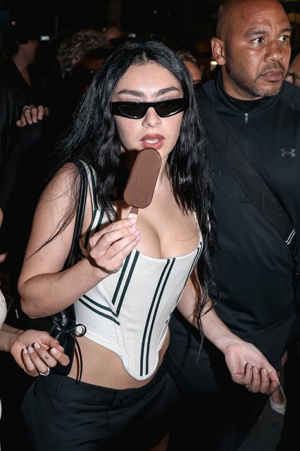 Charli XCX snacks on an ice cream bar while heading to a Magnum party at Cannes on May 16, 2025. (Photo by Alessandro Bremec/ipa-agency.net/Rex Features/Shutterstock)