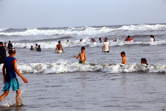 People cool off in the Arabian Sea during a heatwave in Karachi, Pakistan, 24 May 2025. (Photo by Shahzaib Akber/EPA/EFE)