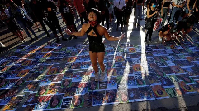 Ameya Okamoto dances over images of victims of police violence at a “Rally for Black Lives, Black Voices and Jacob Blake” in Boston, Massachusetts, U.S., September 5, 2020. (Photo by Brian Snyder/Reuters)