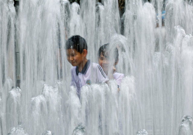 Children cool off in a fountain, amid a heat wave reaching past 36 degrees Celsius, in Shanghai, China, 27 June 2025. (Photo by Alex Plavevski/EPA)