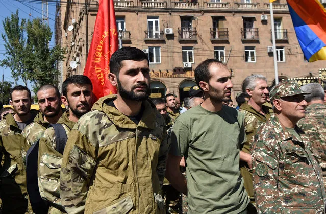 Volunteers of Armenian Revolutionary Federation gather to leave for Artsakh (Nagorny-Karabah region), where martial law has been declared near Aram Manukyan’s statue in Yerevan, Armenia, 27 September 2020. According to media reports, Armenia has imposed martial law and total military mobilisation after clashes have erupted in the territorial conflict between Armenia and Azerbaijan in Nagorno-Karabakh Republic, with both sides reporting civilian deaths after shelling, artillery and air attacks along the front. (Photo by Melik Baghdasaryan/EPA/EFE)