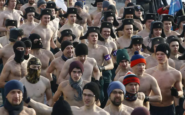 Half-naked participants run at the “Real men's race” to mark the Defender of the Fatherland Day, with the air temperature at about minus 12 degrees Celsius (minus 10.4 degrees Fahrenheit), in Minsk, Belarus February 23, 2018. (Photo by Vasily Fedosenko/Reuters)