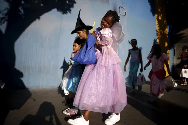 Children participate in the School on Wheels Skid Row Halloween Parade for children who live in shelters, motels, cars and on the street, in Los Angeles, California, United States, October 30, 2015. (Photo by Lucy Nicholson/Reuters)