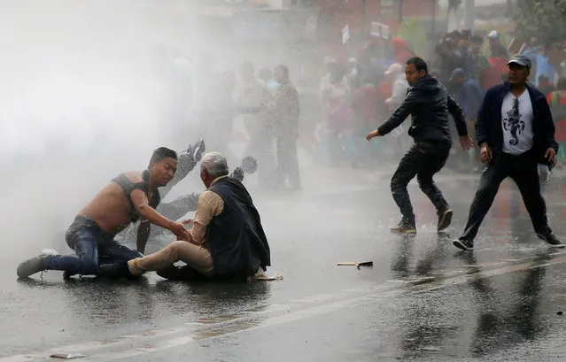 Water cannon is fired towards the protesters to disperse the crowd during a protest against the road expansion projects causing people in the affected areas to lose their houses and lands in Kathmandu, Nepal March 28, 2018. (Photo by Navesh Chitrakar/Reuters)