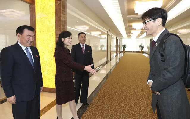 Yun Sang, right, head of South Korean Art Troupe, is greeted by his North Korean counterpart Hyon Song Wol, second from left, at the Pyongyang Airport in Pyongyang, North Korea, Saturday, March 31, 2018. From aging crooners to bubbly K-Pop starlets, some of South Korea's biggest pop stars flew to North Korea on Saturday for rare performances that highlight the sudden thaw in inter-Korean ties after years of tensions over the North's nuclear ambitions. (Photo by Korea Pool via AP Photo)
