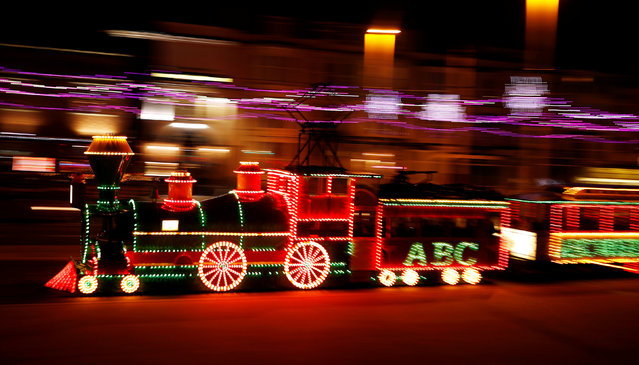 An illuminated tram in the shape of a steam locomotive passes under the illuminations on the promenade in Blackpool, northern England October 13, 2016. (Photo by Phil Noble/Reuters)