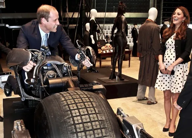Kate the Duchess of Cambridge watches her husband Prince William as he sits on the “Batpod” during the inauguration of “Warner Bros. Studios Leavesden” near London, on April 26, 2013. (Photo by Chris Jackson/Pool)