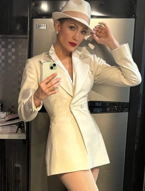 American singer Jennifer Lopez on October 16, 2025 snaps a selfie in a fedora and suit mini dress. (Photo by jlo/Instagram)