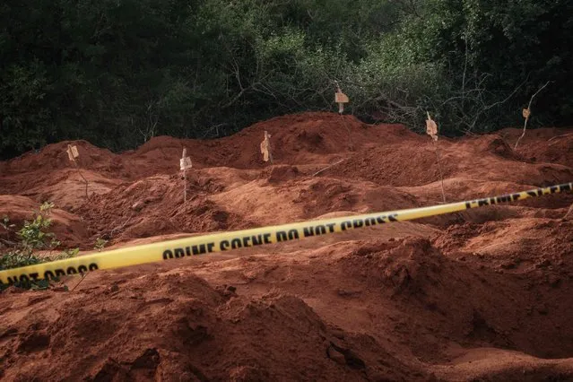 Digged holes are seen after exhuming bodies at the mass-grave site in Shakahola, outside the coastal town of Malindi, on April 25, 2023. Kenyan investigators unearthed another 16 bodies on Tuesday in a forest where a cult was believed to be practising mass starvation, bringing the number of victims so far to 89 including children. There are fears more corpses could be found in Shakahola forest where cult leader Paul Mackenzie Nthenge had allegedly been telling his followers that starvation was the only path to God. (Photo by Yasuyoshi Chiba/AFP Photo)