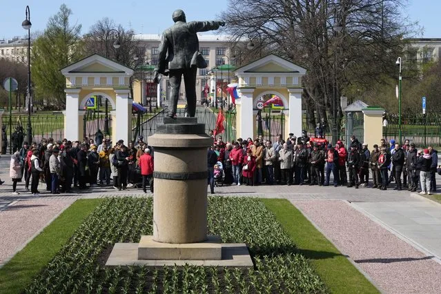 Communists party supporters gather near a statue of Soviet Union founder Vladimir Lenin to mark Labor Day, also known as May Day in St. Petersburg, Russia, Monday, May 1, 2023. (Photo by Dmitri Lovetsky/AP Photo)