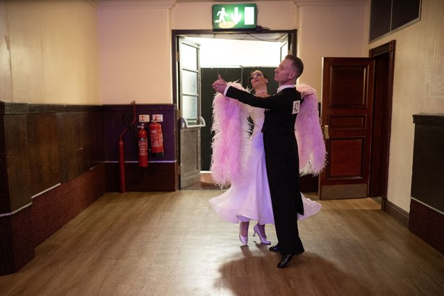 Ballroom dancers Jonathan Noblett and Jennifer Kilheeney practice before competing in the 'Senior (over 35's) Ballroom Championship' discipline of the 50th British National Dance Championships, in the Empress Ballroom of Blackpool's Winter Gardens, in Blackpool, north-west England, on November 20, 2025. The annual, four-day British National Dance Championship features over 2000 entries and showcases 60 hours of competitive dancing, with 23 championship titles in Ballroom and Latin dance disciplines. (Photo by Oli Scarff/AFP Photo)