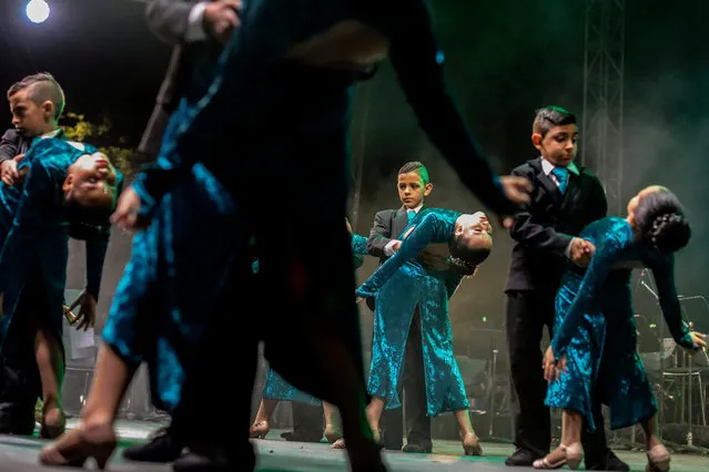 Children perform, during the XII International Tango Festival at the Botero Square in Medellin, Colombia, on June 22, 2018. The Tango Festival takes place from June 18 to 24. (Photo by Joaquin Sarmiento/AFP Photo)