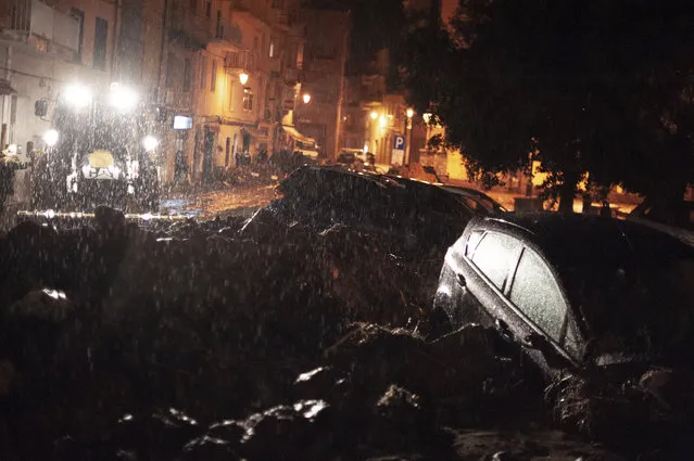 Cars among other debris litter the street in Bitti, Sardinia, Italy, Saturday, November 28, 2020. The town of Bitti in Sardinia was hit by a storm and flooded by a massive mudslide that killed at least 2 people on Saturday.  (Photo by Alessandro Tocco/LaPresse via AP Photo)