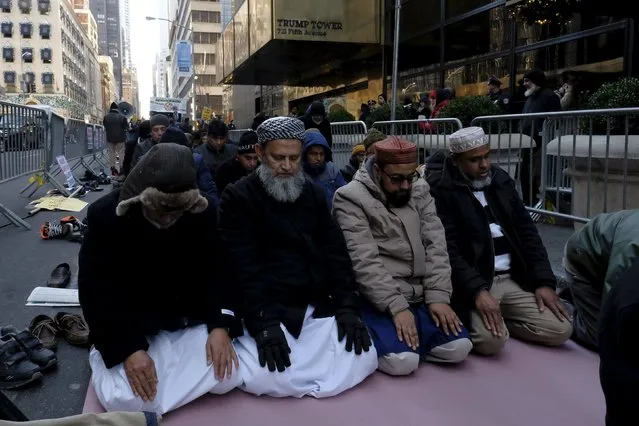 Muslims pray as they take part in a protest against presidential candidate Donald Trump outside of his office in Manhattan, New York December 20, 2015. (Photo by Eduardo Munoz/Reuters)