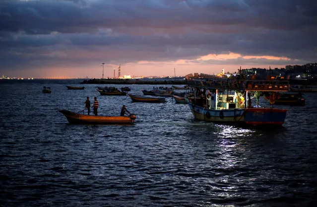 Palestinian fishermen ride their boats as they return from fishing at the seaport of Gaza City early morning September 26, 2016. (Photo by Mohammed Salem/Reuters)