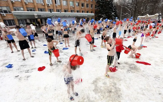 Participants douse themselves with cold water during a patriotic event titled “Being Healthy is Fashionable” held in Krasnogorsk, Moscow Region, Russia on February 23, 2021, to mark Defender of the Fatherland Day. (Photo by Vyacheslav Prokofyev/TASS)