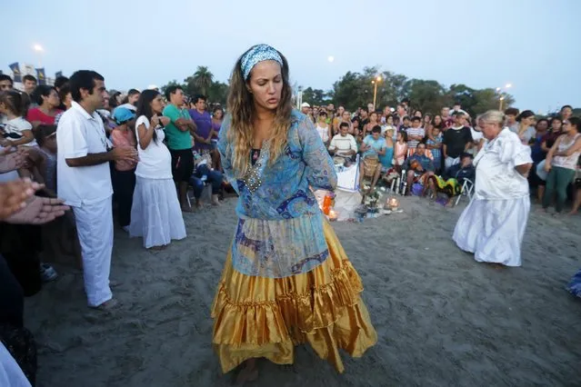 Devotees of the Afro-Brazilian goddess of the sea Lemanja pay tribute on Lemanja's Day at Ramirez beach in Montevideo February 2, 2015. (Photo by Andres Stapff/Reuters)