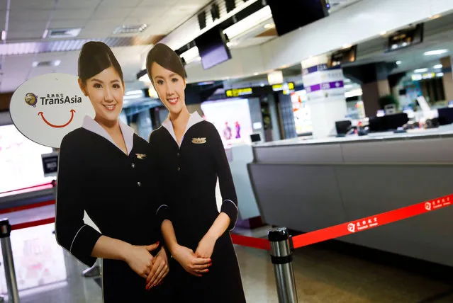 A paper cutout depicting flight attendants of Taiwan's third-largest airline, TransAsia Airways Corp. is seen in front of its counter after the company applied to suspend its flights without giving any earlier warning at Songshan Airport in Taipei, Taiwan November 21, 2016. (Photo by Tyrone Siu/Reuters)