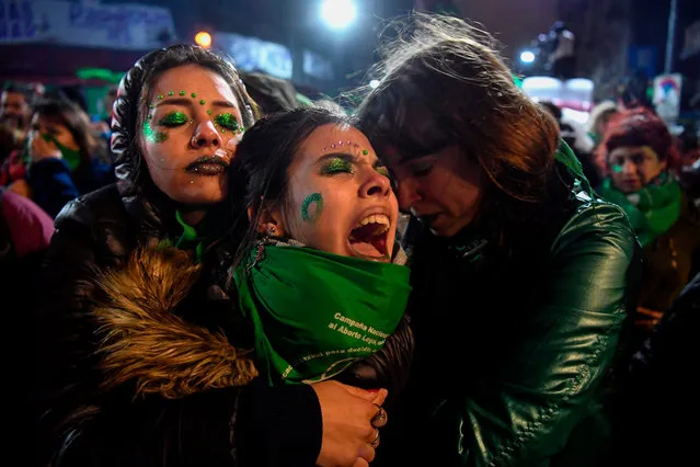 Activists in favour of the legalization of abortion comfort each other outside the National Congress in Buenos Aires, on August 9, 2018 after senators rejected the bill to legalize the abortion. -Argentine senators on Thursday voted against legalizing abortion in the homeland of Pope Francis, dashing the hopes of women' s rights groups after the bill was approved by Congress' s lower house in June. According to an official tally, 38 senators voted against, 31 in favor, while two abstained. (Photo by Eitan Abramovich/AFP Photo)
